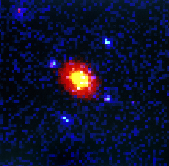 Gravitational lensing by an elliptical galaxy Gravitational lens. Hubble Space Telescope image of a galaxy acting as a gravitational lens. Here an elliptical galaxy  yellow and red  causes light from a more distant object to be seen as four faint blue images in a cross shaped pattern. The enormous gravity of the foreground galaxy warps space nearby. This warping  bends  light, magnifying and distorting the image of the distant object. This is normally seen as arcs or a pair of images  quadruple images are rare. Studies of such objects may lead to a measurement of the density of matter in the Universe, and thus whether it will expand forever or eventually collapse.