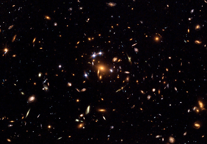 Quintuple quasar  SDSS J1004 4112  Quintuple quasar  SDSS J1004 4112 , optical image. Quasars are very distant yet luminous astronomical objects. They are the centres of active galaxies, emitting vast quantities of radiation as matter gravitates towards supermassive black holes. The quintuple quasar is in fact a single quasar, but five images of it are seen as a result of gravitational lensing. A large mass concentration, in this case a cluster of galaxies, between the quasar and Earth bends and amplifies the light, causing multiple images  seen as the bright orange spot, centre, and the four bright nearby spots, white . The quasar lies around 7 billion light years from Earth in the constellation Leo Minor. This image, taken by the Hubble Space Telescope  HST , also shows several other lensed images of galaxies.