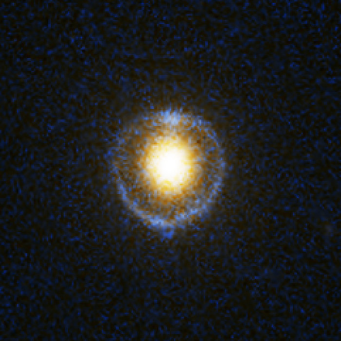 Galactic gravitational lensing, HST image Galactic gravitational lensing, Hubble Space Telescope image. The blue ring surrounding the galaxy  yellow  is light from another galaxy behind this one. The light from the background galaxy has been lensed by the gravitational field of the foreground galaxy, forming what is known as an Einstein Ring. This galaxy s catalogue name is SDSS J162746.44 005357.5, indicating that it was discovered by the Sloan Digital Sky Survey  SDSS . It is one of eight giant elliptical galaxies with Einstein Rings, all around 2 to 4 billion light years away, that were discovered by the Sloan Lens ACS Survey  SLACS , and announced in November 2005.