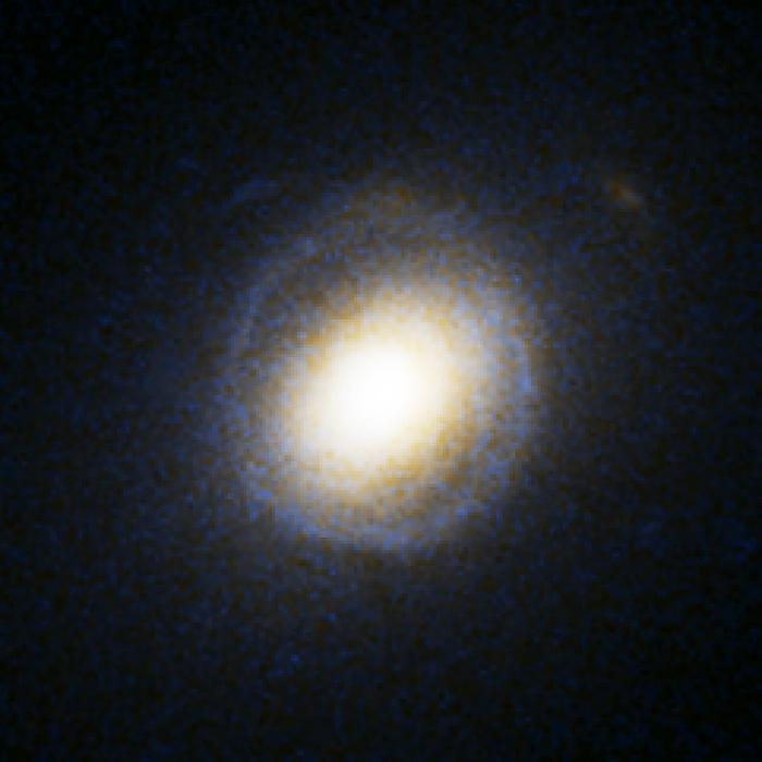 Galactic gravitational lensing, HST image Galactic gravitational lensing, Hubble Space Telescope image. The blue ring surrounding the galaxy  yellow  is light from another galaxy behind this one. The light from the background galaxy has been lensed by the gravitational field of the foreground galaxy, forming what is known as an Einstein Ring. This galaxy s catalogue name is SDSS J232120.93 093910.2, indicating that it was discovered by the Sloan Digital Sky Survey  SDSS . It is one of eight giant elliptical galaxies with Einstein Rings, all around 2 to 4 billion light years away, that were discovered by the Sloan Lens ACS Survey  SLACS , and announced in November 2005.