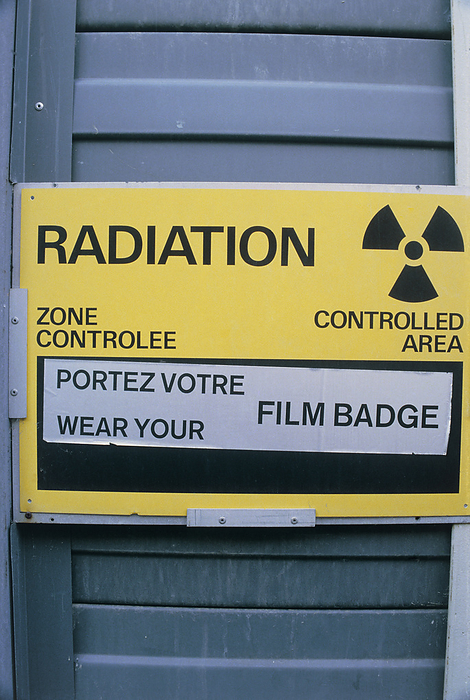 Radiation symbol Radiation symbol and warning notice in English and French, situated on a door to an experimental area at CERN, the european particle physics laboratory, Geneva. Photographed in September 1984.