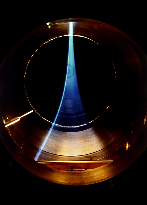 Hydrogen isotope plasma The blue haze of a hydrogen isotope plasma, part of the Tandem Mirror Experiment  TMX  at Lawrence Livermore National Laboratory, U. S. The TMX experiment is designed to test the stability of superhot fusion fuel  ie plasma  confined by a magnetic field in a novel geometry. Nuclear fusion reactions are accompanied by a vast release of energy, which may potentially be harnessed for electrical power generation. Here, the ions and electrons that constitute the hot plasma appear to be trapped along the lines of the magnetic field. The bending effect is caused by the plasma approaching a region of increased magnetic field.