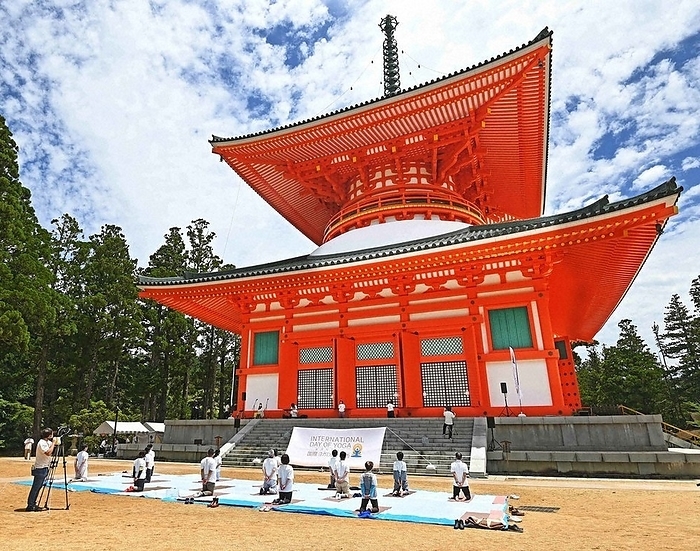  Participants practice yoga in front of the Nemoto  Great Pagoda  in the Danjo Temple during the online broadcast of  Yoga for 1,000 People,  held in honor of International Yoga Day.  Participants in the online broadcast of  Yoga for 1,000 People,  held in commemoration of International Yoga Day, practice yoga in front of the Nemoto  Great Pagoda  of the Danjo Temple in Koya Town, Wakayama Prefecture, June 20, 2021.