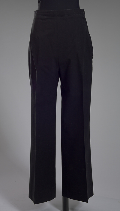 US Navy dress uniform pants worn by Admiral Michelle Howard, 1999. Creator: Weintraub Brothers Company, Inc.. Four star Admiral Michelle Howard  born 1960  was the first African American woman to command a United States Navy ship. In 2014 she was appointed Vice Chief of Naval Operations, the second highest ranking officer in the US Navy. A pair of US Navy women s dress uniform pants worn by Admiral Michelle Howard as commander. The straight leg pants are made from a black synthetic fabric and close at the proper left side waist with a zipper and one  1  black plastic button. There is one  1  exterior inset pocket at the proper right front waist. The pants have a thin waist band that is lined in white ribbon with a tan decorative woven design. The pants are not lined. A size and style tag is sewn at the interior proper left back side.