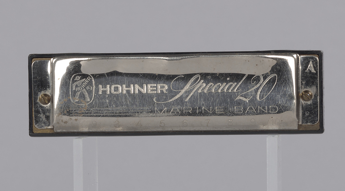 Harmonica used by Arthur Lee, ca. 1980. Creator: Hohner Musikinstrumente GmbH  amp  Co. KG. A metal and plastic harmonica used by African American singer songwriter Arthur Lee. The harmonica is etched with lettering on the top and bottom. The lettering on the top of the harmonica reads   x201c HOHNER Special 20   MARINE BAND.  x201d  The letter   x201c A  x201d  is etched on the top right side of the harmonica. The etched lettering on the bottom of the harmonica reads   x201c M. HOHNER   MADE IN GERMANY.  x201d  The harmonica has ten holes on each of its sides. Numbers are etched in the metal above each hole.