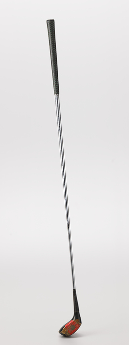 Wood 4.5 golf club used by Ethel Funches, late 20th century. Creator: Unknown. A wood golf club used by African American golfer Ethel Funches. The shaft is silver in color and is made out of metal. There is a black rubber grip at the top. The grip has short green diagonal lines going in both directions all around it. In the center there is a line drawing of an arrow like shape. There is text going vertically down both sides of the arrow. On the proper right side of the arrow it reads  GRIP RITE  and on the proper left side it reads  SWING RITE .