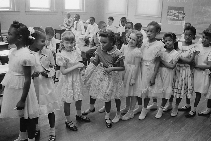 School integration. Barnard School, Washington, D.C. Line of African American and white schoolgirls standing in a classroom while boys sit behind them:  27 May 1955. Photographer: Thomas J O'Halloran.