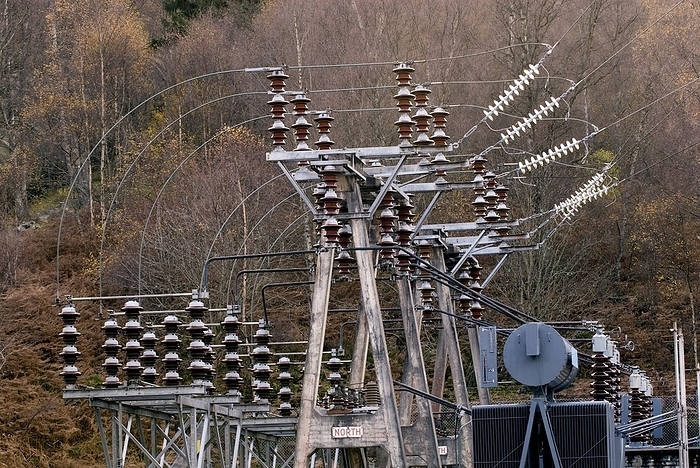 Ceramic insulators Ceramic insulators and voltage switching gear at an electricity substation. Photographed at Loch Tummel hydroelectric power station, Perthshire, Scotland, UK.