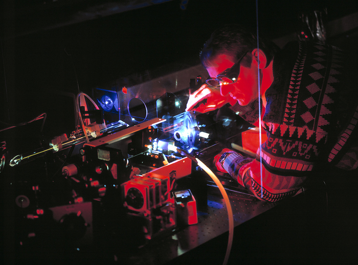 Laser research Laser research. Scientist researching the use of pigment lasers to analyse chemical reactions.