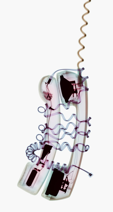 Phone support Phone support. Conceptual coloured X ray of entwined telephone handsets representing the emotional support that can be received through the telephone from a friend.