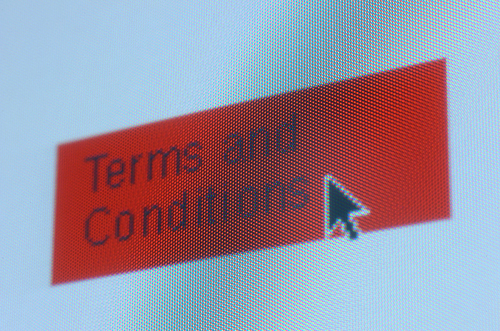 Internet transaction Internet transaction. Computer screen shot of a mouse cursor pointing at the terms and conditions button during a transaction over the internet, the worldwide computer communications network.