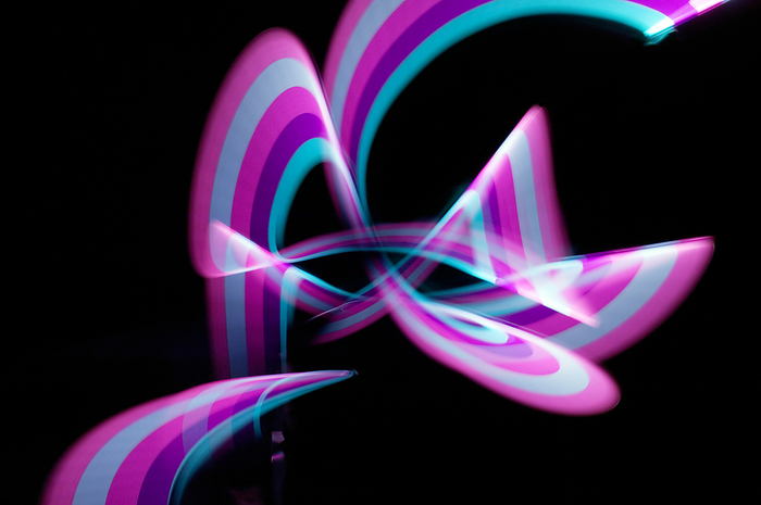 Sound waves, conceptual image Sound waves. Time exposure image of moving plastic rings, representing sound.