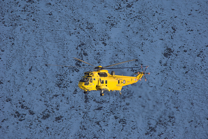 Mountain rescue Mountain rescue. RAF rescue helicopter during an operation in the Cairngorms mountain range. Photographed in Cairngorms National Park, Scotland, in November.