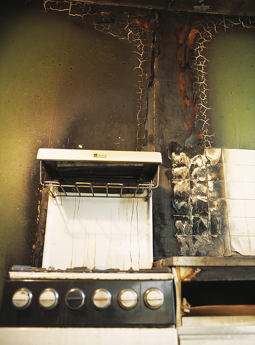 Fire damaged kitchen Fire damaged kitchen. Blackened, sooty kitchen walls following a house fire. The blistered paint on the walls is indicative of the intense heat generated. A cooking oil fire  chip pan  may have caused this damage, as shown by the splashes on the back of the cooker.
