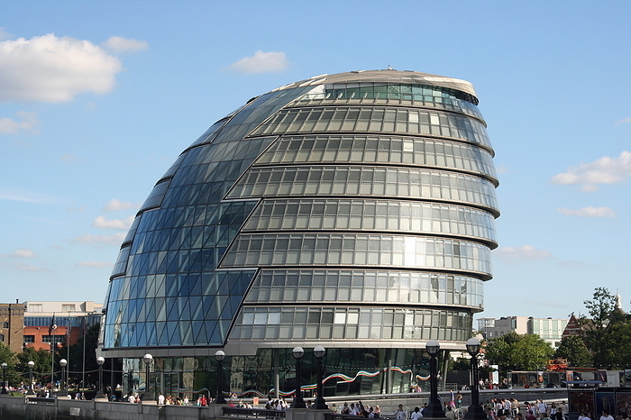 City Hall City Hall, Southwark, London, England. City Hall houses the assembly chamber for the London Assembly and the offices of the Mayor of London and the Greater London Authority. It is situated on the south bank of the River Thames. The design of City Hall was aided by computer modelling techniques which enabled its advanced energy  saving design features. The unusual modified sphere shape minimises exposure to direct sunlight creating optimal energy exchange. The south of the building  right  leans back so that its floor plates jut outwards, creating shade for the offices below. Parts of the building are open to the public. It was completed in late December 2001.