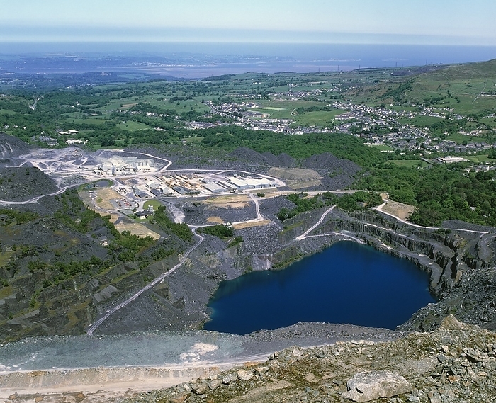 View of the Penrhyn slate quarry, North Wales Slate quarry. View of the Penrhyn slate quarry in Bethesda, North Wales. In the foreground is a disused and flooded pit. The currently mined site is behind it  centre left . This quarry is one of the largest in the world. It is well over 200 hectares in size, and goes down over 350 metres. Excavations started at this quarry in 1765. In the distance  top centre , the island of Anglesey can be seen, separated from the mainland by the Menai strait.