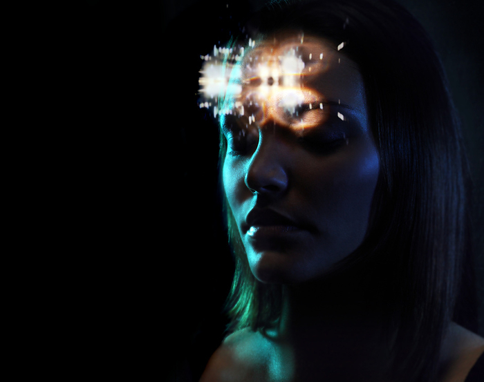 Mind reading, conceptual image MODEL RELEASED. Mind reading. Conceptual image of a woman s thoughts being scanned represented by light over her head.