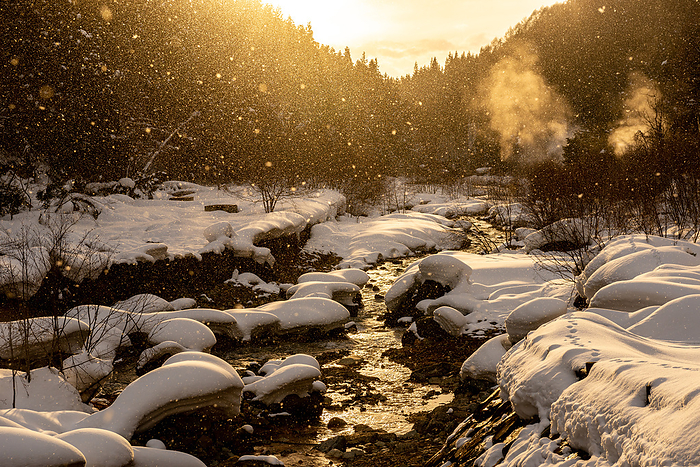Dusk on the Onsen River flowing into the snowy mountains