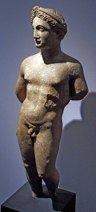 Statue of a naked youth.  About 300-100 BC, Cyprus, local limestone.  Wears hair in braids, wrapped around his head, fastened by a thin head-band.  This hairstyle suggests that he might be the god Apollo.