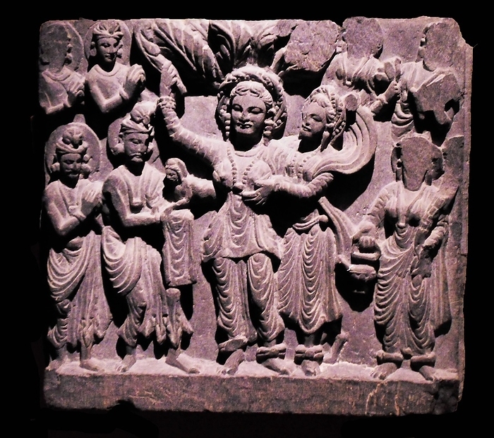 Birth of the Budha.  Gandhara, about AD 200.  Schist.  Standing in a grove, Queen Maya gave birth to Prince Siddhartha Gautama, the future Buddha, from her right side.  The infant is receved by the god Indra, whilst other deities stand in attendance.