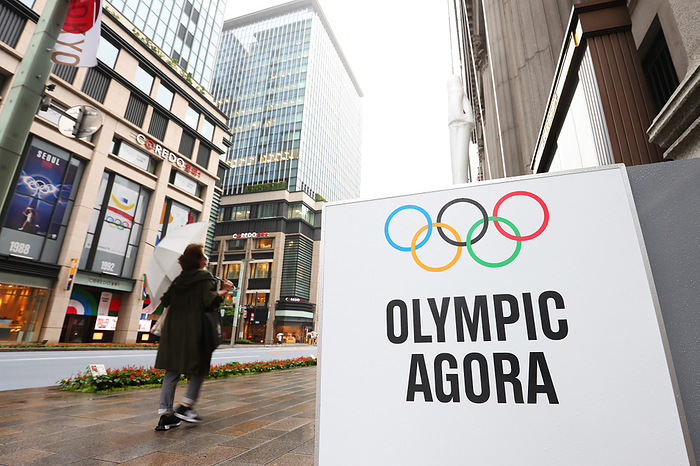 Tokyo 2020 Preview July 2, 2021, Tokyo, Japan: A pedestrian walks in front of a sign promoting the  Olympic Agora  project in the Nihonbashi area in Tokyo, Japan. Created from a collaboration between the Olympic Foundation for Culture and Heritage and Mitsui Fudosan Co., Ltd., the  Olympic Agora  project aims to create a confluence of sport, art and culture in the heart of Tokyo, renovating the ancient Greek tradition of the Agora, a public space where people can gather to exchange ideas.  Photo by Yohei Osada AFLO SPORT 