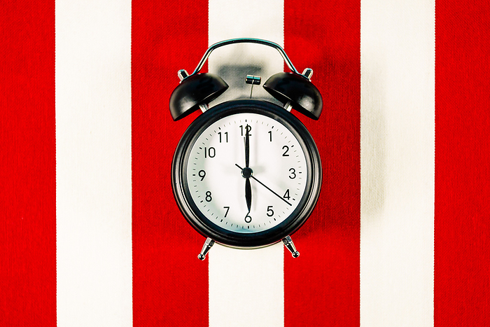 sevilla, Spain, coffee time, still life Alarm clock lying on white and red striped pattern