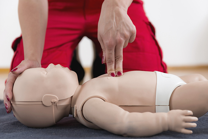 Infant cardiopulmonary resuscitation training First Aid Training. Cardiopulmonary resuscitation. First aid course on baby dummy., Photo by MICROGEN IMAGES SCIENCE PHOTO LIBRARY