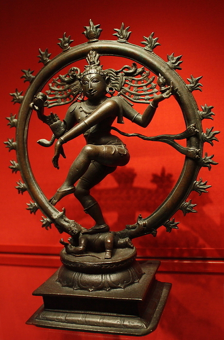 Shiva Nataraja, Lord of the Dance, bronze, Vijayanagar, 1450-1500.  Encircled by flames, Shiva as Cosmic Dancer dances the universe into being, sustains it with his rhythm and dances it back into annihilation.  He holds a hand drum and a flame in his upper hands.  His lower hands make the fear-dispelling gesture and point to his raised foot, the worship of which leads to salvation.  His other foot bears down on the dwarf Apasmara who represents Maya or illusion.
