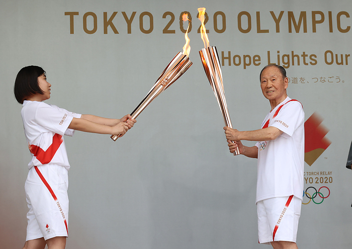 2020 Tokyo Olympics Torch Relay July 9, 2021, Tokyo, Japan   Japanese legendary gymnast Takashi Ono  R  who won 13 medals including 5 golds and 1964 Tokyo Olympics Japanese delegation captain kisses the torches with another torch bearer  L  at the Olympic torch relay event in Tokyo on Friday, July 9, 2021. Tokyo 2020 Olympics torch relay started in Tokyo on July 9, two weeks before the opening of the Olympic Games.    Photo by Yoshio Tsunoda AFLO  