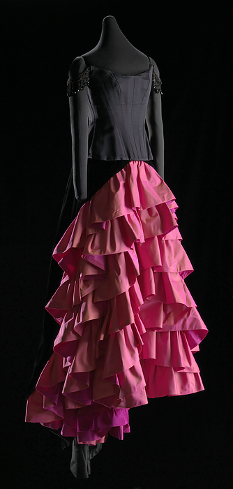 Dress worn by Denyce Graves in Washington National Opera s production of Carmen, 1993 1994. Creator: Unknown. This black corset and pink ruffled skirt were designed by Donna Langman and worn by African American mezzo soprano opera singer Denyce Graves as the lead in the Washington National Opera s production of Carmen during the 1993 1994 season. The corset  a  is made from black silk satin and is sleeveless and strapless.