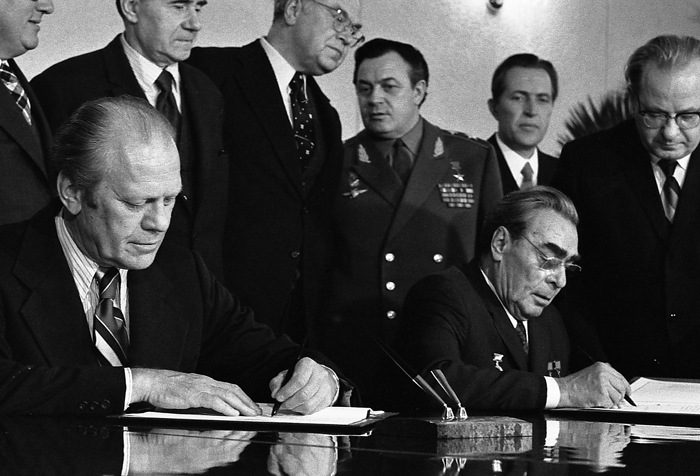 President Gerald Ford and Soviet General Secretary Leonid Brezhnev sign a Joint Communiqu? following talks on the limitation of strategic offensive arms. The document was signed in the conference hall of the Okeansky Sanitarium, Vladivostok, USSR.  1974