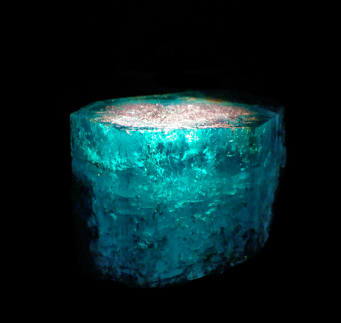 Glowing minerals.  A number of different minerals appear to glow in the dark when they are energized by ultraviolet light, invisible to our eyes.  They release this energy as light in a part of the spectrum we can see.  This phenomenon is known as fluorescence.