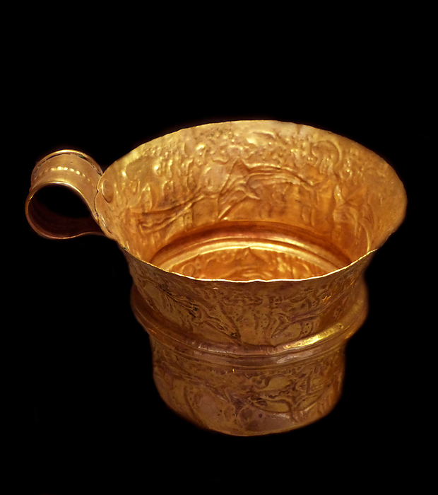 Gold cup with repose representation of dolphins within a seascape. Mycenaean Greece was a cultural period of Bronze Age Greece taking its name from the archaeological site of Mycenae