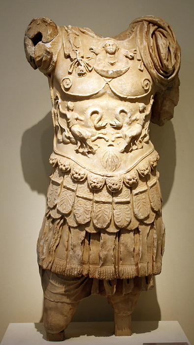 Statue of a man wearing a corselet, made of Pentelic marble, found at Megara.  The statue depicted a general or an emperor.  The corselet ends in tongues decorated with lion's heads and palmettes, below which are fringed thongs.  AD 100-130