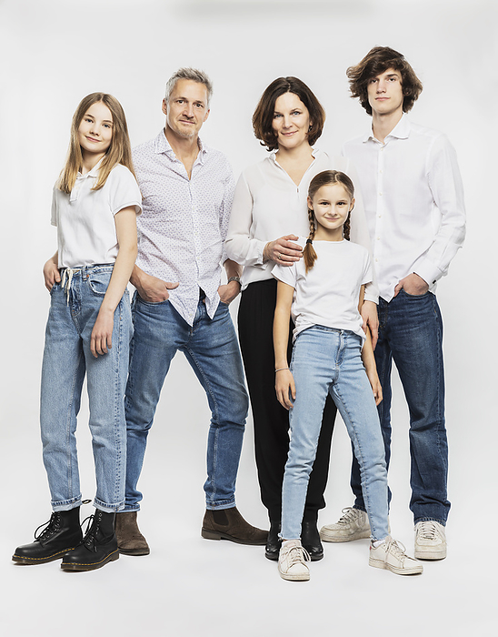 Lifestyle Happy family with children standing against white background