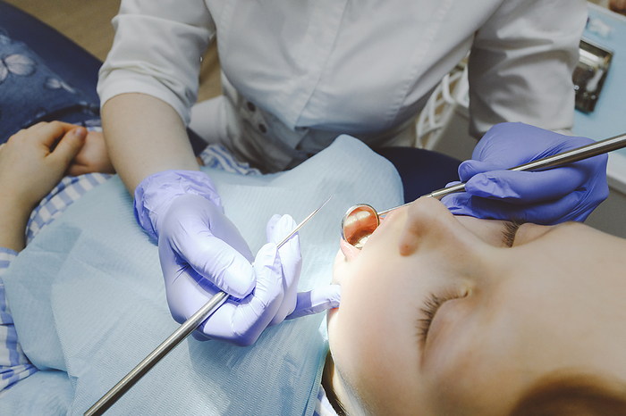 Russia, Ryazan, dentist examining patient Little girl during dental exam