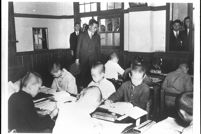 Emperor Hirohito  later, Emperor Showa, first in the back row  makes a nationwide pilgrimage to watch a class at a national school in Toyohashi, Aichi. Emperor Hirohito  posthumous title: Emperor Showa  watching a class at Haccho National School in Toyohashi City during a tour of the Chubu region of Japan. The Showa History of 100 Million People   5 , p. 151 
