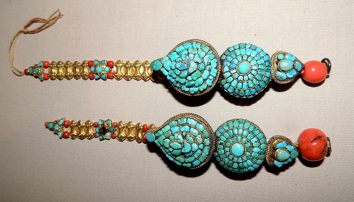 Hair ornaments 19th century A.D. Hair ornaments, 19th century AD, Tibet. Made with turquoise and coral in gilt copper. These were secured at the side of the head, hanging down in front of the ears.