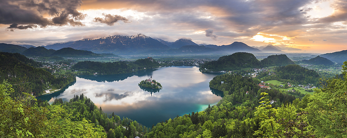 Lake Bled landscape at sunrise, seen from Osojnica Hill, Julian Alps, Gorenjska, Slovenia, Europe Beautiful Lake Bled and mountain landscape under dramatic sunset sky and clouds, seen from Osojnica Hill, Julian Alps, Gorenjska, Slovenia, Europe