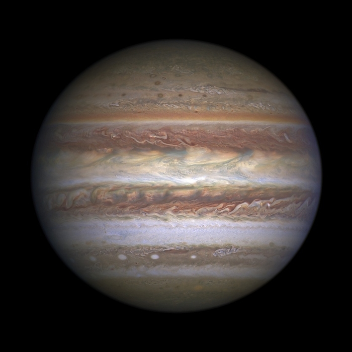 Jupiter, Hubble Space Telescope image Hubble Space Telescope image of Jupiter. Jupiter is a gas giant planet, the fifth planet from the Sun and is the largest in the solar system. The Great Red Spot and bands of clouds are seen in Jupiter s turbulent atmosphere. The colours, and their changes, indicate ongoing processes in Jupiter s atmosphere. The bands are created by differences in the thickness and height of the ammonia ice clouds. The bands of clouds, which flow in opposite directions at various latitudes, result from different atmospheric pressures. Lighter bands rise higher and have thicker clouds than the darker bands. Composite image captured by Hubble s Wide Field Camera 3 when Jupiter was 701 million kilometres from Earth., Photo by NASA, ESA, and M.H. Wong  UC Berkeley  SCIENCE PHOTO LIBRARY