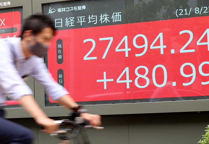 Japane s share prices rose 480.99 yen at the Tokyo Stock Exchange August 23, 2021, Tokyo, Japan   A cyclist passes before a share prices board in Tokyo on Monday, August23, 2021. Japan s share prices rebounded 480.99 yen to close at 27,494.24 yen at the Tokyo Stock Exchange.     Photo by Yoshio Tsunoda AFLO 