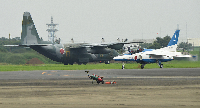 Taliban seize control of Afghan government, dispatch SDF planes A C130 transport aircraft  left  takes off for evacuation support activities for Japanese nationals remaining in Afghanistan. On the right is a Blue Impulse aircraft entering the runway for a display flight before the opening ceremony of the Tokyo Paralympics.