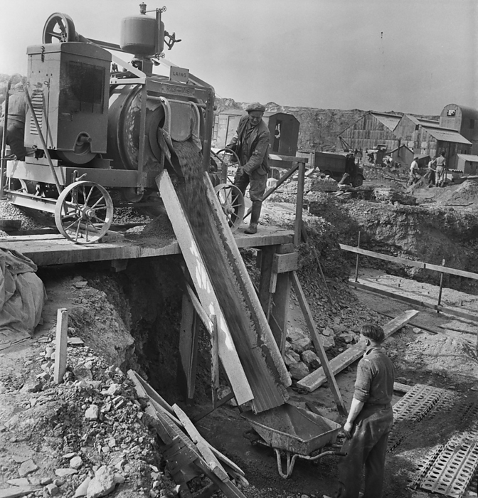 Plymouth  B  Power Station, City of Plymouth, 1949. Creator: John Laing plc. A view of concrete being poured from a mixer into a wheelbarrow below, during work on the foundations for Plymouth  B  Power Station. This image was catalogued as part of the Breaking New Ground Project in partnership with the John Laing Charitable Trust in 2019 20.