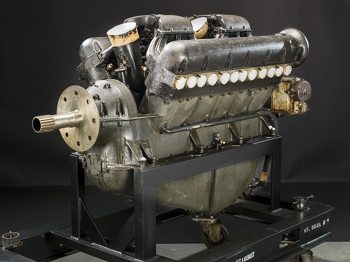 Curtiss K 12, V 12 Engine, ca. 1918. Creator: Curtiss Aeroplane and Motor Company. In 1916 Curtiss engineer Charles Kirkham began designing an engine to compete with the Wright Corporation s Hispano Suiza. By late 1917, the prototype K 12  K for Kirkham  was bench tested. While it met its design objectives of high power, low frontal area, compact size, and low weight, the engine encountered technical difficulties during development. Kirkham left Curtiss in 1919, and Arthur Nutt took over the project, eventually producing the D 12, which became a highly successful racing and military power plant in the 1920s. This engine is manufacturer s number 5 out of about 20 built. The K 12 powered the Curtiss Navy 18T Wasp triplane and the Army Curtiss 18B Hornet biplane. In 1919 Curtiss test pilot Roland Rholfs set a new world s altitude record of 10,641 m  34,910 ft  with the 18T.