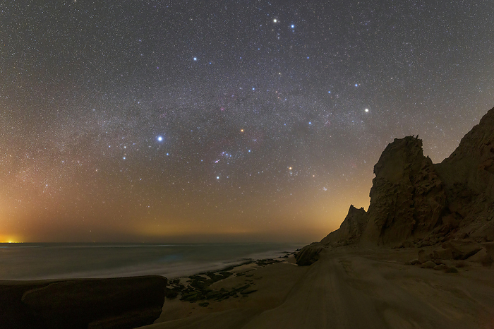 Stars over Persian Gulf, Iran Stars of  winter constellations shining over a rocky shore in the Persian Gulf, southern Iran. The winter Hexagon asterism, consisting of six bright stars from six winter constellations, is clearly visible., Photo by AMIRREZA KAMKAR   SCIENCE PHOTO LIBRARY