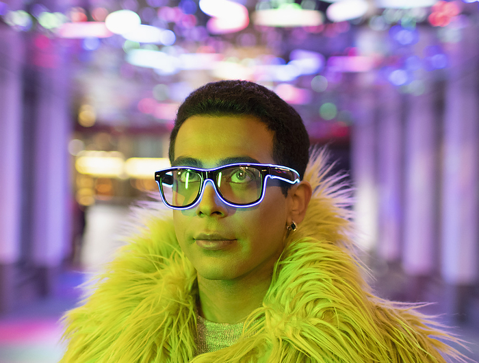 masculine gender Portrait stylish young man in feather boa and neon eyeglasses