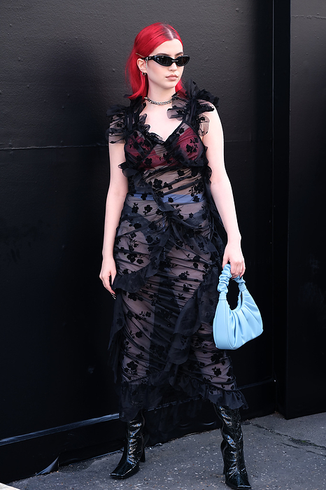 2022 Spring Summer London Street Snapshots Street style shot on day one of London Fashion Week, season Spring Summer 2022, on Saturday September 18th 2021. Stylish guests and attendees arriving at or departing various live catwalk fashion shows or presentations. Image shows Social Media and TikTok star Abbey Roberts, wearing a sheer black dress by Yuhan Wang, a blue bag and her signature red hair