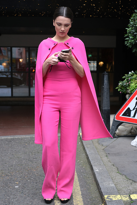 2022 Spring Summer London Street Snapshots Street style shot on day one of London Fashion Week, season Spring Summer 2022, on Sunday September 19th 2021. Stylish guests and attendees arriving at or departing various live catwalk fashion shows. Image shows Maya Henry wearing a pink ensembleof trousers, top and cape by Roland Moured