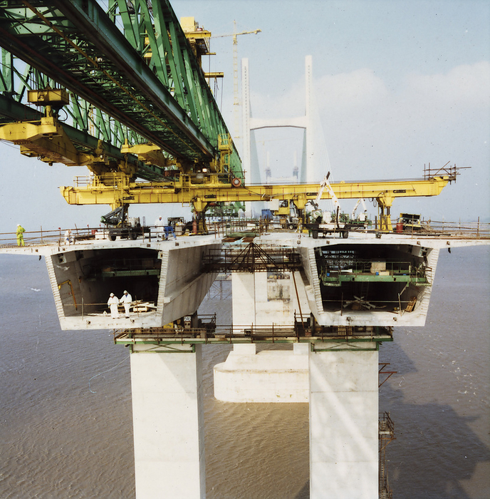 Second Severn Crossing, M4, New Passage, Pilning and Severn Beach, Glos, 118 09 95   19 09 95. Creator: John Laing plc. A view of bridge deck units being installed during the construction of the Second Severn Crossing, showing a specially designed launch gantry overhead and two workers standing inside one of the deck units. The Second Severn Crossing took four years to build and was a joint civil engineering project between Laing Civil Engineering and the French company GTM. The work started in April 1992 and the opening ceremony later took place on 5th June 1996. The crossing is a cable stayed bridge which stretches over 5000 metres across the River Severn connecting England and Wales, 3 miles downstream from the Severn Bridge which opened in 1966.