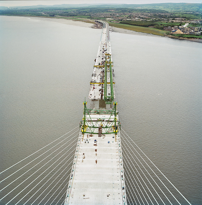 Second Severn Crossing, M4, New Passage, Pilning and Severn Beach, Gloucestershire, 18 10 1995. Creator: John Laing plc. A view looking west from the top of a bridge pylon during the construction of the Second Severn Crossing, showing a space awaiting a deck unit to connect the sections of the bridge and Wales with England. The Second Severn Crossing took four years to build and was a joint civil engineering project between Laing Civil Engineering and the French company GTM. The work started in April 1992 and the opening ceremony later took place on 5th June 1996. The crossing is a cable stayed bridge which stretches over 5000 metres across the River Severn, 3 miles downstream from the Severn Bridge which opened in 1966.